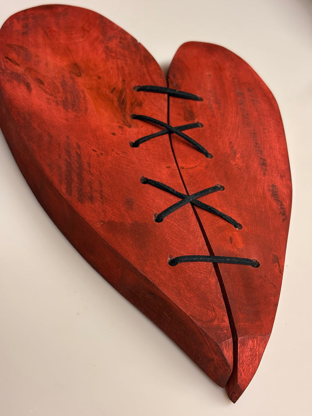 Repaired sculpted wooden heart – handcrafted wall decoration – symbolic laced heart